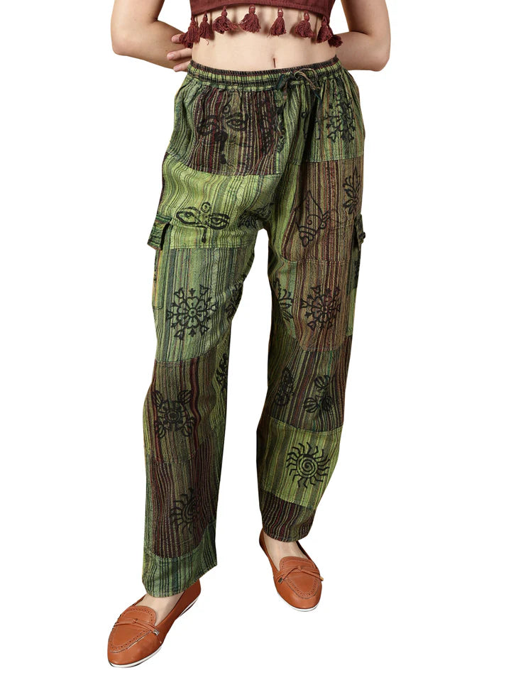 Green and brown patterned pants worn by a person on a white background