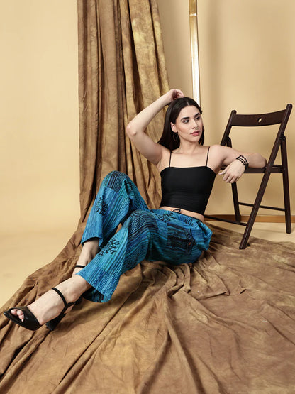 Woman sitting on a draped fabric with a curtain in the background