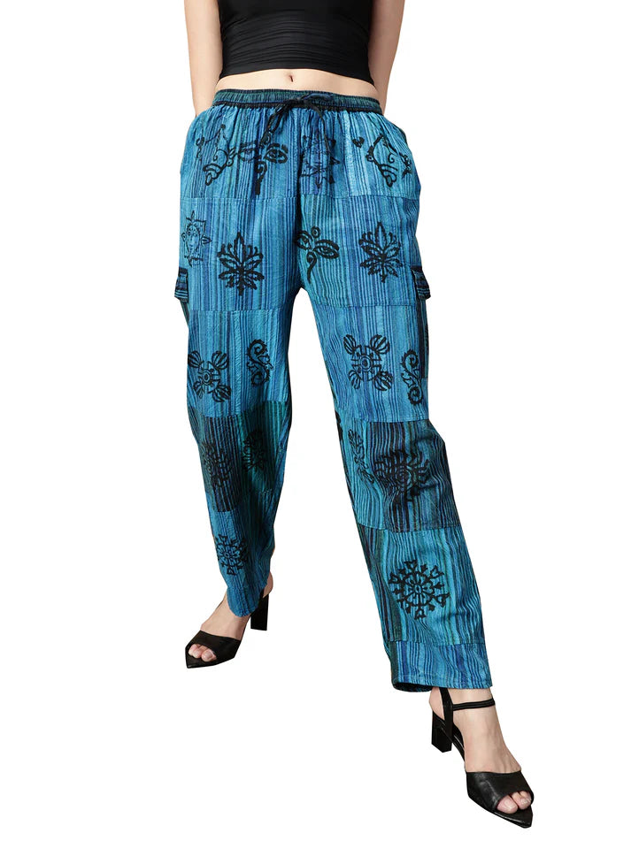 Blue embroidered pants worn by a person on a white background