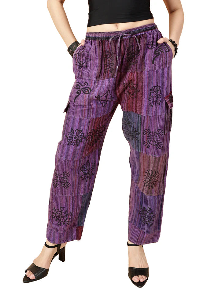 Purple patterned pants worn by a person on a white background