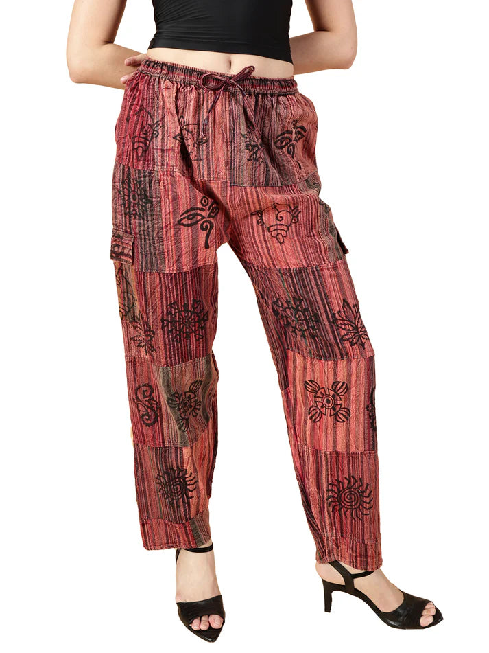 Red patterned pants worn by a person on a white background