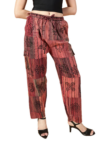 Red patterned pants worn by a person on a white background